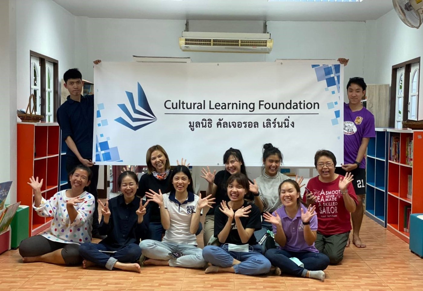 A group of community members and volunteers smiling together